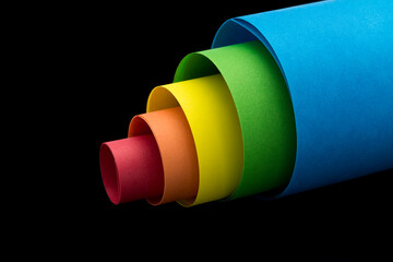 Wall Mural - Rolled color paper sheets on black background