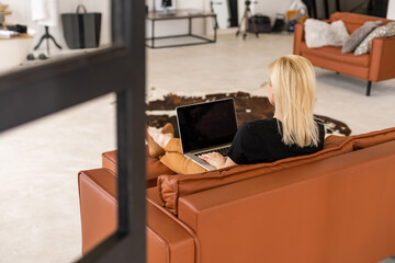 young beautiful woman using a laptop computer at home