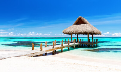 Wall Mural - Panorama of beautiful gazebo on the tropical white sandy beach in Punta Cana, Dominican Republic.