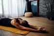 © chika_milan - Woman practicing yoga at home.