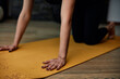 © chika_milan - Cutout picture of a woman kneeling on a yoga mat and practicing yoga.