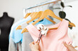 Organic cotton clothing. Hanger with dresses in the store. Sustainable fashion, caring for the environment.