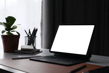 Fototapete - Computer tablet with blank screen, house plant and pencil holder on home office desk.