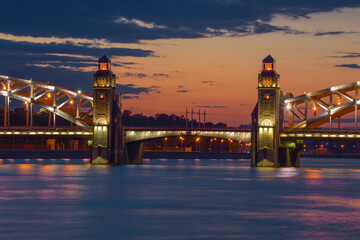 The central part of the Bolsheokhtinsky (Peter the Great) bridge against the background of a June sunset. Saint Petersburg, Russia