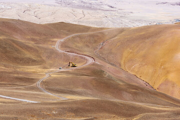 Wall Mural - A pickup truck and excavator parked on a Tibetan wilderness trail