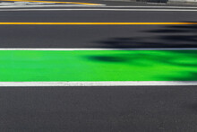Road Markings On Gray Asphalt, Yellow And Bright Green Lines