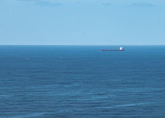 Cargo Ship Leaving Port on Calm Sea