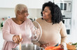 © Alessandro Biascioli - Happy Afro mother and daughter preparing lunch together in modern house kitchen - Food and parents unity concept