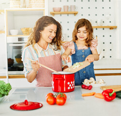 Wall Mural - family child kitchen food daughter mother father cooking preparing breakfast  happy together