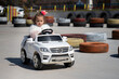 young children are getting traffic education with fun. girl and boy are having fun driving battery cars.