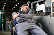 © Вячеслав Думчев - Tired factory worker sleeps at workplace near production line breaking rules