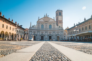 Square of the Cathedral of Sant'Ambrogio (Duomo di Vigevano) by day, blue sky