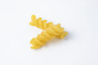 Two units of raw fusilli pasta. Uncooked ingredient of Italian food isolated on white background