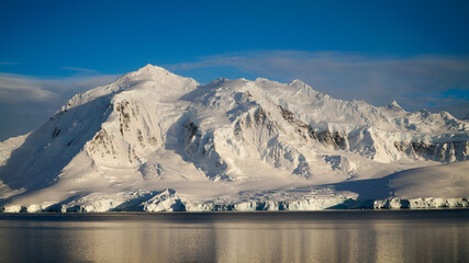 Wall Mural - Snow covered Mountains and Icebergs in the Antarctic Peninsula on Antarctica.