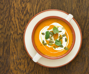 Wall Mural - Pumpkin soup on a gray background. Selective focus.