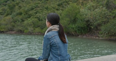 Poster - Woman sit at lakeside on pier