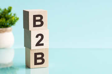 three wooden cubes with letters b2b - short for business to business, concept