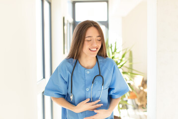 Poster - pretty nurse laughing out loud at some hilarious joke, feeling happy and cheerful, having fun