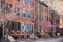 Rows Of Brownstone Apartment Buildings In Center City With Windows, Stoops And Planters In Pennsylvania