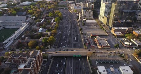 Wall Mural - Atlanta, Georgia USA - 4-2-2021: Cinematic aerial tilting clip over Interstate-85 northbound in downtown Atlanta.