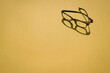 © sinseeho - Eye glasses with shadow on yellow top background.