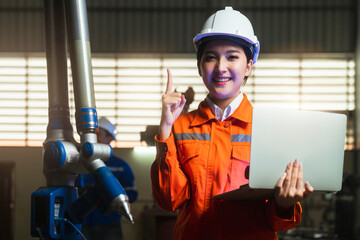 engineer specialist asian female and  technician maintenance inspect relay robot arm system with laptop  to control quality operate process work heavy industry 4.0 manufacturing smart factory