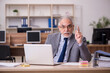 © Elnur - Old male employee working in the office