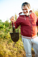 Portrait of a man with a search magnet. His hobby is magnetic fishing.