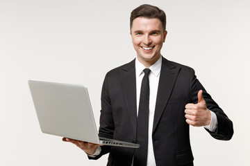 Young employee business corporate lawyer man wearing classic formal black grey suit shirt tie work in office hold laptop pc computer show thumb up gesture isolated on white background studio portrait