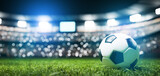 Fototapeta Sport - Football soccer ball on grass field on stadium