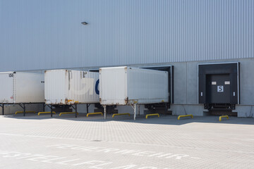 trucks at loading ramps of a warehouse