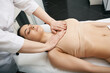 © Peakstock - Masseur doing decollete massage to woman patient for skin firmer and more resilient at a spa salon