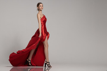 fashion woman strides in long red dress