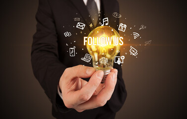 Businessman holding a light bulb, social media concept