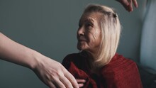 Young Person Covering His Grandmother With Red Blanket. Care Of Elderly People In Nursing Home. High Quality 4k Footage