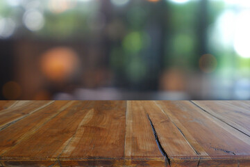 Empty wooden table in front of abstract blurred Cafe, restaurant at night. For montage product display or design key visual layout - Image