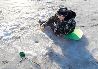 Sticker - The boy is fishing on ice