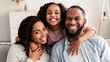 © Prostock-studio - Portrait of a happy black family smiling at home