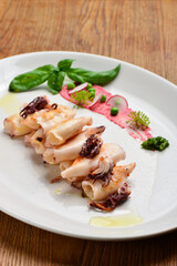 Wall Mural - Fresh  grilled calamari served in an old Italian restaurant