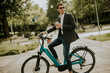 © BGStock72 - Young businessman on the ebike with takeaway coffee cup