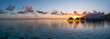 © JCB - Overwater bungalows at a luxury beach resort at sunset