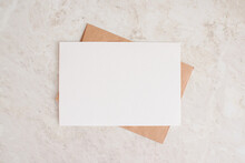 Blank Card Mock Up. Layout Of Sheet Of Paper On Craft Envelope And Marble Texture. Horizontal Canvas Template For Greeting, Wedding Cards, Invitations. Natural Beige Colors.