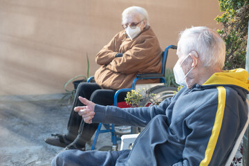 Wall Mural - Elderly man and woman waiting outdoor to receive Covid-19 Vaccine, thinking about possible side effects