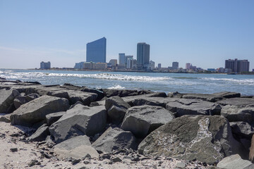 Wall Mural - View on large hotel casino buildings with a rocky jetty in the foreground