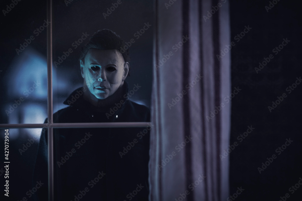 Slasher Breaking Through Window NEW YORK USA: APRIL 14 2021: Halloween horror movie slasher Michael ...