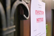 © Вячеслав Думчев - the notice of eviction of tenants hangs on the door of the house, front view