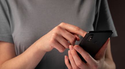 Poster - Female hands holding phone and making appointments. Student using smartphone at night
