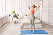 © shunevich - Sportive beautiful woman exercise at home, doing jumping jacks. Happy blonde-hair female fitness trainer is working out, smiling, healthy lifestyle and everyday training concept