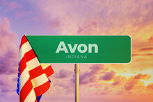 Avon - Indiana/USA. Road Or City Sign. Flag Of The United States. Sunset Sky.