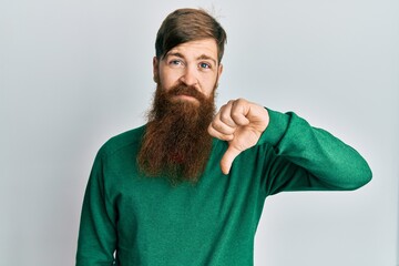 Canvas Print - Redhead man with long beard wearing casual clothes looking unhappy and angry showing rejection and negative with thumbs down gesture. bad expression.